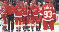  ?? GREGORY SHAMUS/GETTY IMAGES ?? Dylan Larkin of the Red Wings is helped off the ice by teammates after being injured in the first period against the Senators on Dec. 9.