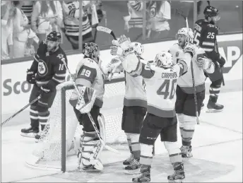  ?? CP PHOTO ?? Vegas Golden Knights players congratula­te goaltender Marc-Andre Fleury (29) after time the team defeated the Winnipeg Jets during NHL Western Conference Finals, game 5, in Winnipeg, Sunday.