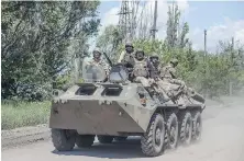  ?? IRYNA RYBAKOVA VIA AP ?? Ukrainian soldiers ride an APC on the frontline near Bakhmut, the site of fierce battles with the Russian troops in the Donetsk region, Ukraine, on Monday.