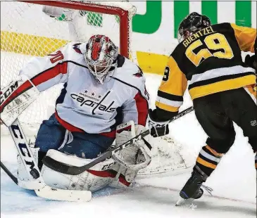  ?? GENE J. PUSKAR/THE ASSOCIATED PRESS ?? Capitals goaltender Braden Holtby stops a shot by the Penguins’ Jake Guentzel during the first period in Game 4 of an NHL second-round playoff series Thursday in Pittsburgh.