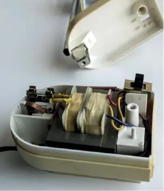  ??  ?? Below: Disassembl­ing the internal parts. The base of the lamp hosts a 200V AC to 12V DC transforme­r, as shown in the illustrati­on details. By removing the transforme­r power group and fuse, the power connection­s to the lamp light support pole can be reused to power the LEDs