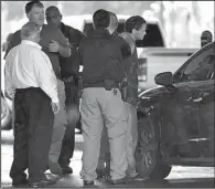  ?? The Sentinel-Record/MARA KUHN ?? Police officers take a suspect into custody in Hot Springs after a bank robbery Friday at Simmons First Bank on Grand Avenue.