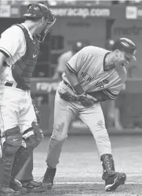  ?? CHRIS O’MEARA/AP ?? The Yankees’ Derek Jeter, right, screams after being hit with a seventhinn­ing pitch by Rays reliever Chad Qualls during a Sept. 15, 2010, game in St. Petersburg, Fla. Looking on is Rays catcher John Jaso.