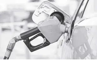  ?? AP/DAVID ZALUBOWSKI ?? A MOTORIST fills up the tank on a sedan, on July 22, 2022, in Saratoga, Wyo. Gasoline prices are sliding back toward the $4 mark for the first time in more than five months—good news for consumers who are struggling with high prices for many other essentials.