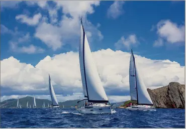  ??  ?? Even on charter boats, close-quarters maneuverin­g is always exciting (top). But one of the reasons many sailors love Caribbean racing is the point-to-point distance contests that take the fleet on a challengin­g course around the islands (above).