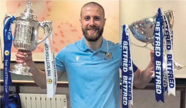  ?? ?? HANDS ON THE TROPHIES: Shaun Rooney with the Scottish Cup and League Cup won with St Johnstone in 2021, when he scored in both finals.