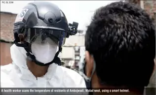  ?? PIC: BL SONI ?? A health worker scans the temperatur­e of residents of Ambojwadi, Malad west, using a smart helmet.