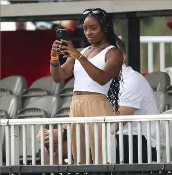  ?? Associated Press ?? Olympic gymnast Simone Biles watches the Houston Texans practice Aug. 6 in Houston. Biles is at peace with her decision to opt out of several competitio­ns at the Tokyo Olympics to focus on her mental health.