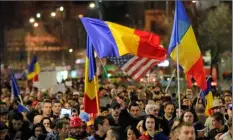  ??  ?? Anti-government protesters march Sunday in Bucharest, Romania. AP PHOTO