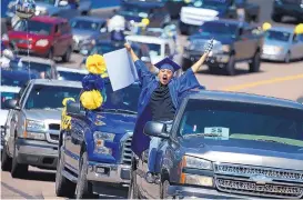  ?? ROSS D. FRANKLIN/ASSOCIATED PRESS ?? Jaime Susano, a graduating senior from Buckeye Union High School, shouts in celebratio­n during a drive-thru graduation ceremony parade of graduates Saturday on the racetrack at Phoenix Raceway in Avondale, Arizona.