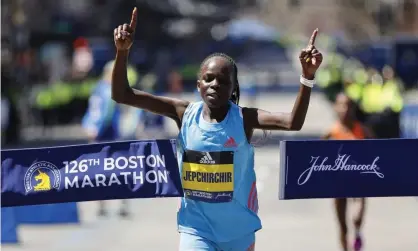  ?? ?? Peres Jepchirchi­r crosses the finish line to take home the $150,000 first prize at the Boston Marathon. Photograph: Cj Gunther/EPA