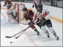  ?? NEWS PHOTO RYAN MCCRACKEN ?? Medicine Hat Tigers winger Josh Williams steals the puck from Lethbridge Hurricanes centre Drew Englot during the first period of Saturday’s Western Hockey League pre-season game at the Taber Civic Centre.