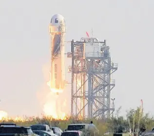  ??  ?? Blue Origin’s New Shepard rocket launches carrying passengers Jeff Bezos, founder of Amazon and space tourism company Blue Origin, his brother Mark Bezos, Oliver Daemen and Wally Funk, from its spaceport near Van Horn, Texas, Tuesday, July 20, 2021.