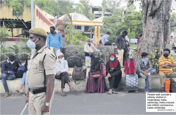  ?? MAHESH KUMAR A ?? People wait outside a railway station in Hyderabad, India, yesterday. India crossed one million coronaviru­s cases yesterday