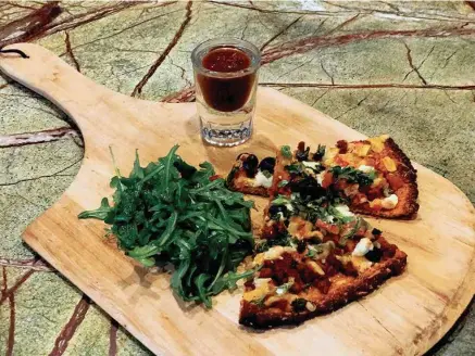  ?? PHOTO BY BARRY COURTER ?? We made this pizza using sweet potato as the base for the crust. The toppings include Mexican chorizo, black olives, pico salsa, onion and a chipotle sauce on the side. Served with a simple arugula salad, it made for a delicious meal, and it was simple to make.