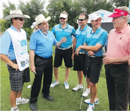  ?? GAVIN YOUNG/POSTMEDIA ?? Eddie Melville, far left, listens as his brother Billy gives instructio­ns to players, including pro golfer Michael Allen, right, at the start of their RBC Pro Am round at the Shaw Charity Classic in Calgary. Eddie was a caddy during the event on...