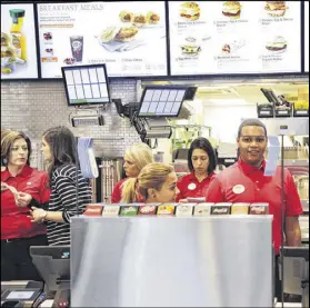  ?? MARK LENNIHAN / AP 2015 ?? Employees familiariz­e themselves with a new Chick-fil-A restaurant in New York. A group of Pittsburgh students were opposed to having the eatery at their college.