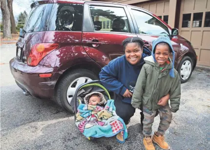  ?? MICHAEL SEARS / MILWAUKEE JOURNAL SENTINEL ?? Marticia Jenkins and her children, Logan, 4, and Olivianna, nearly 1, happily pose with the car purchased for them with money raised in a GoFundMe campaign online.