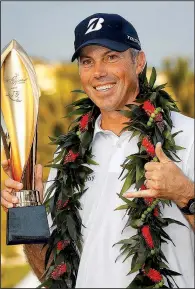  ?? AP/MATT YORK ?? Matt Kuchar holds the championsh­ip trophy after the final round of the Sony Open on Sunday at Waialae Country Club in Honolulu. Kuchar closed with a 4-under 66 to win the tournament for his second PGA Tour title this wraparound season.