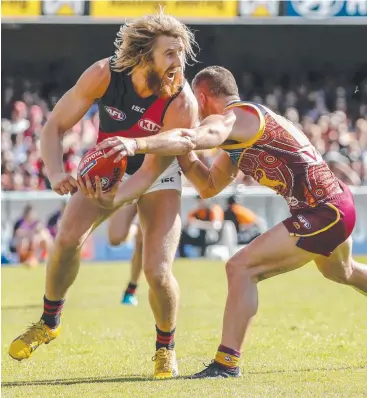  ?? Picture: AAP ?? MOMENTUM SHIFTS: Dyson Heppell of the Bombers gets caught by Dayne Zorko of the Lions in yesterday’s Round 12 clash at the Gabba.