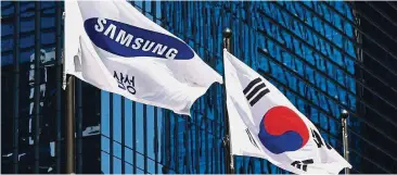  ??  ?? Iconic brand: A Samsung flag and the South Korean national flag flutter outside the Samsung building in Seoul. The company’s investment is part of a broader 180 trillion won package South Korea’s biggest business group is planning to spend over the period to create jobs and secure new growth areas. — AFP