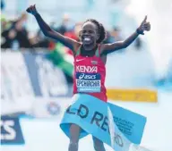  ?? (AFP) ?? Peres Jepchirchi­r of Kenya celebrates after setting a new world record en route to winning the women’s race at the 2020 IAAF World Half Marathon Championsh­ips in Gdynia, Poland.