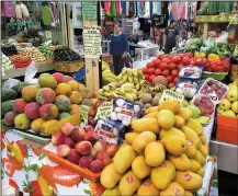  ??  ?? Fresh fruits and vegetables are dizzyingly colorful in an indoor bazaar in Mazatlan’s Centro Historico.