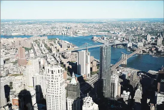  ??  ?? Manhattan, Brooklyn, and the Queens boroughs seen from One World Observator­y at One World Trade Center on Aug 22, in New York City. The observatio­n deck sits atop the 104-story skyscraper
at the site of the former Twin Towers and is one of Manhattan’s...