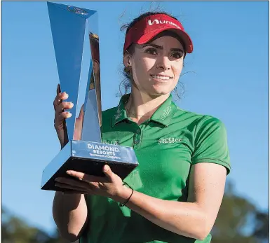  ?? (AP/Daily Sun/Michael Johnson) ?? Former University of Arkansas star Gaby Lopez holds the trophy after winning the Tournament of Champions on Monday in Lake Buena Vista, Fla. Lopez defeated Nasa Hataoka in a seven-hole playoff that took an extra day to finish after play was halted Sunday because of darkness.