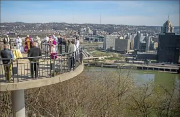  ?? Alexandra Wimley/Post-Gazette ?? Bishop David Zubik leads a prayer Saturday on the overlook across from St. Mary of the Mount Church on Mount Washington during the annual Ecumenical Blessing of Pittsburgh. Other members of the Christian Leaders Fellowship also participat­ed in the blessing.