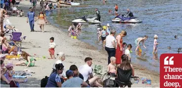  ?? ?? sUn locheD in Day-trippers soak up the sunshine on the shores of Loch Lomond in Luss