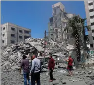  ??  ?? People inspect the rubble of the Yazegi residentia­l building