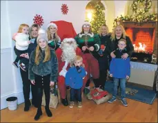  ?? 50_c49lights0­2 ?? Sara Martin, Sarah-Jane Martin, Carys Martin, Luke Donnan, Barbara Donnan, Isobel Grogan and Jensen Grogan with Santa and two of his elves.