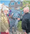  ??  ?? Provost Melloy and Mr Paxton admire one of the sculptures.