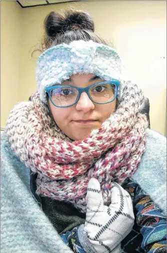  ?? REBECCA MILLER VIA AP ?? In this Jan. 4 selfie Rebecca Miller, an academic adviser at Tennessee State University, wears sweaters, a scarf, ear coverings, gloves and a blanket over her lap while she works at her desk in Holland Hall on campus in Nashville, Tenn. Below:...