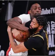  ?? (AP/Mark J. Terrill) ?? Los Angeles Lakers forward Anthony Davis (front) and Miami Heat forward Bam Adebayo battle for a rebound during Game 5 of the NBA Finals on Friday in Lake Buena Vista, Fla. Miami won 111-108 to cut its series deficit to 3-2.