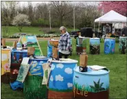  ?? ?? At the Conservati­on Celebratio­n on Saturday, April 23, at the Berks County Agricultur­al Building in Bern Township, rain barrels painted by Berks County student for a competitio­n based on this year’s theme, “Healthy Soil, Healthy Life.” Lori Snyder, New Tripoli, Lehigh County, looks over the artwork.