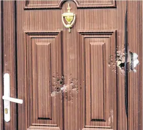  ?? PHOTO: DOUGLAS O’CONNOR ?? Damage:A door of a house shot at in Corduff Place, Dublin, was the fourth shooting in eight hours.
