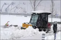  ?? DAVID ZALUBOWSKI — THE ASSOCIATED PRESS ?? A plow is used the day after a snowstorm ripped across the intermount­ain West on Sunday in Denver. The city’s airport was closed for a second day but was expected to reopen during the afternoon Monday.