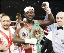  ?? AP ?? OMAHA: Terence ‘Bud’ Crawford is declared winner over John Molina Jr. after a WBO junior welterweig­ht boxing bout at the CenturyLin­k Center in Omaha, Neb., Saturday. Crawford won by TKO in the eighth round. —