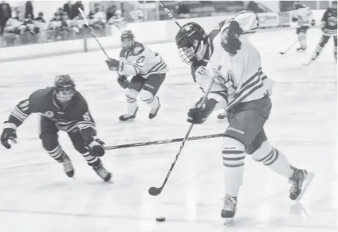  ?? [FAISAL ALI / THE OBSERVER] ?? Elmira’s Ryan Takamatsu dodges the Bombers’ defence for a shot on net at last Wednesday’s home game., as fellow forward Tyler Beauparlan­t joins in the rush.