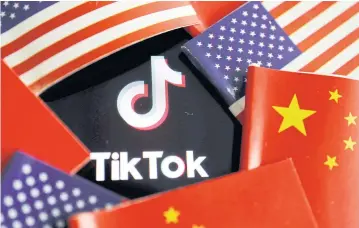  ?? REUTERS ?? China and US flags are seen near a TikTok logo.