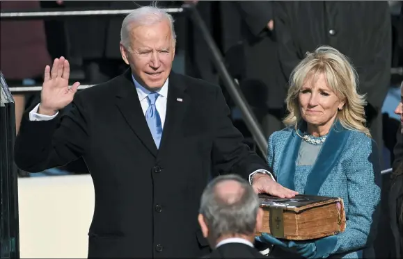  ?? SAUL LOEB — POOL PHOTO VIA AP ?? Joe Biden is sworn in as the 46th president of the United States by Chief Justice John Roberts as Jill Biden holds the Bible during the 59th Presidenti­al Inaugurati­on at the U.S. Capitol in Washington, Jan. 20,