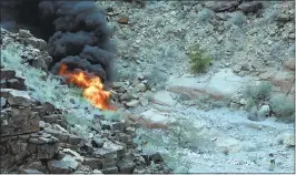  ?? TEDDY FUJIMOTO VIA AP ?? A survivor, lower right, walks away from the scene of a deadly tour helicopter crash Saturday evening along the jagged rocks of the Grand Canyon, in Arizona.