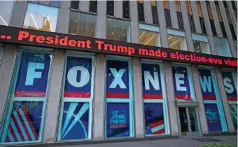  ?? AP PHOTO/MARK LENNIHAN ?? A headline about President Donald Trump is displayed outside Fox News studios in 2018 in New York.