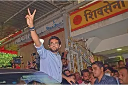  ?? — DEBASISH DEY ?? Shiv Sena leader and Maharashtr­a minister for tourism and environmen­t flashes victory sign as he comes out of Sena Bhavan after a meeting party leaders at Dadar in Mumbai on Friday.