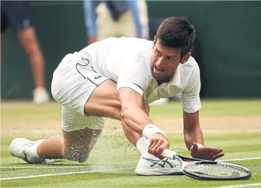  ?? OLI SCARFF/AFP/GETTY IMAGES ?? Novak Djokovic digs deep for a return after his semifinal against Rafael Nadal — suspended Friday night by darkness — resumed at the All England Club on Saturday.