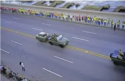  ??  ?? HAVANA: People line the Malecon seaside boulevard as they watch the motorcade transporti­ng the remains of Cuban leader Fidel Castro. — AP