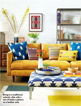  ?? ?? Bring in a traditiona­l eclectic vibe with a mix of kelim cushions on a leather sofa