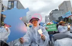  ?? — AFP ?? South Korean peace group members during a rally to wish for peace and success at the upcoming summit between US President Donald Trump and North Korean leader Kim Jong Un, near the US embassy in Seoul on Saturday.